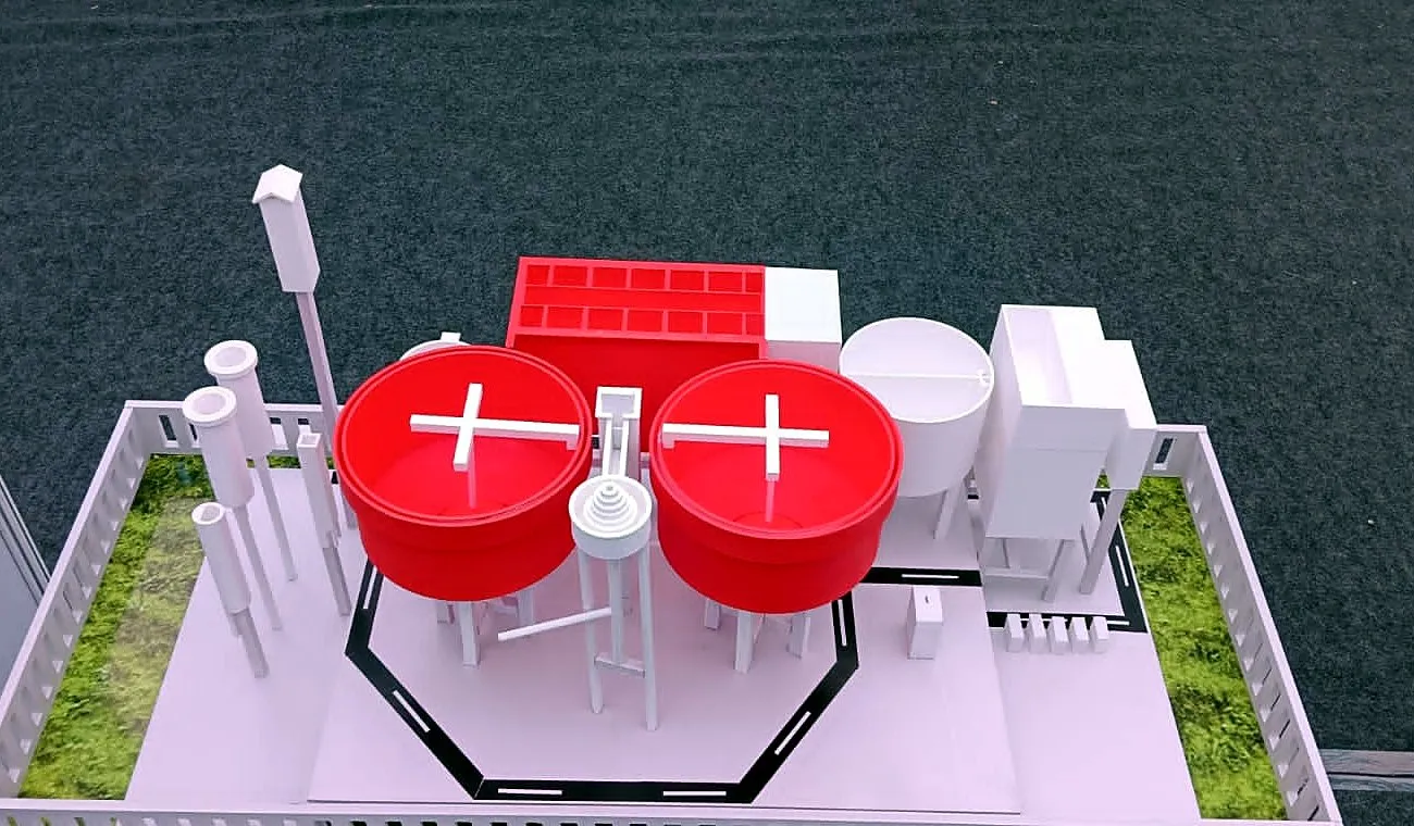 Twin red circular clarifiers with bridges on a 3D-printed water treatment plant model